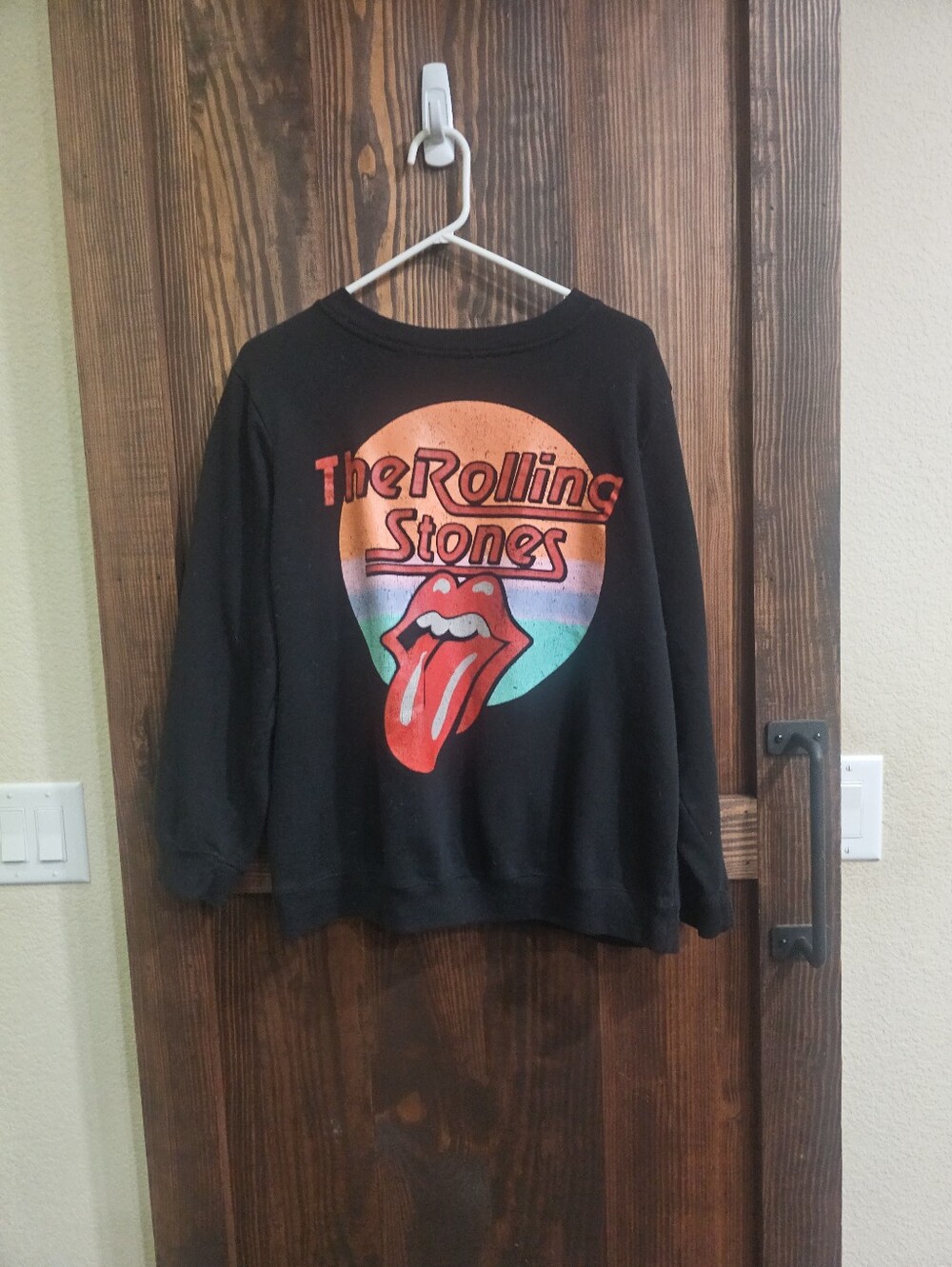 the Rolling Stones Black Crewneck with Red Tongue and Sunset Graphic